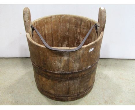 A vintage oak and steel banded bucket with loose iron work loop handle 