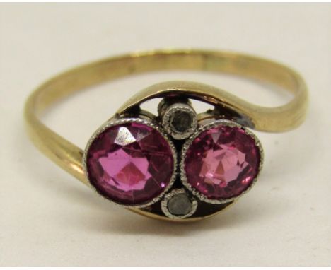 A pink ruby and diamond crossover ring with millegrain detail, in unmarked yellow metal, size Q, 2.1g