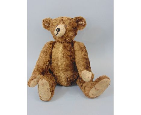 A reproduction Steiff like bear in a brown mohair finish, 40cm high approx with jointed limbs, pronounced muzzle and partly s