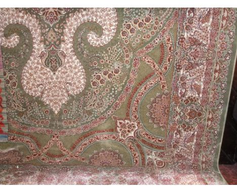 Good quality Sha Qum fine wool carpet, with tight floral scrolled weave upon a light green ground, 300 x 200cm 