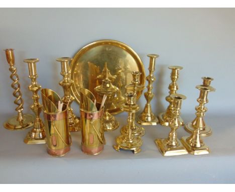 A large collection of various brassware include candlesticks, a fire curb, mirror, large tray, mirrored firescreen, etc