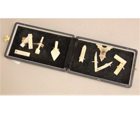 A collection of eight miniature carved bonework Masonic emblems, trowel, dividers, set square, etc
