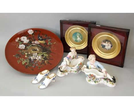 A 19th century terracotta charger with painted decoration of a bird at its nest amongst brambles, painted monogram to reverse