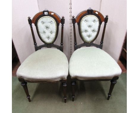 A pair of mid-Victorian ebonised and burr walnut drawing room chairs with upholstered seats and back, raised on turned and fl