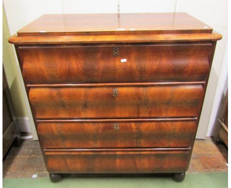 A mid 19th century continental mahogany commode, the four drawers with scalloped outline and with well matched flame veneers 