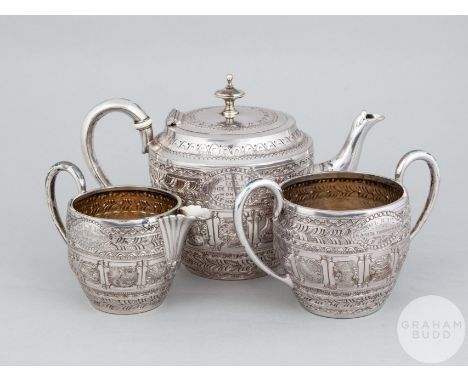 Hugh Smith white-metal zodiac three-piece bachelors tea-service comprising teapot, sugar bowl and cream jug, teapot inscribed