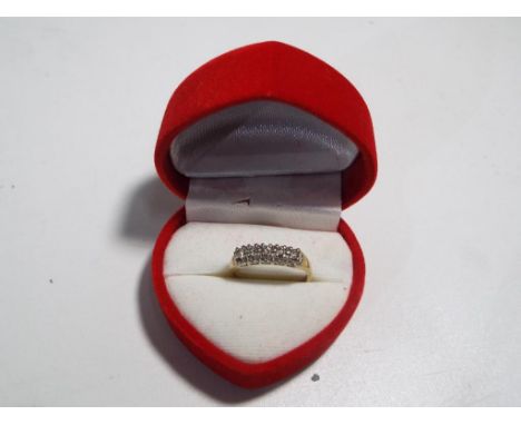 A 14 carat gold ring set with five diamonds stamped 14k, size M, approximate weight 2.05 grams, boxed. Estimate £60 - £80