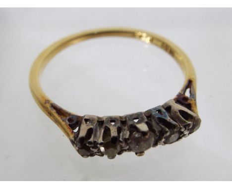 A lady's 18 ct gold ring set with five stones, approximate weight 2.65 g.