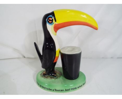 A ceramic lamp base  in the form of a Guinness toucan with pint, marked Carlton Ware