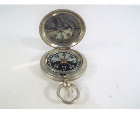 A white metal British military compass marked with crow's foot/wide arrow Stanley London 114452, circa 1917 inscribed interna