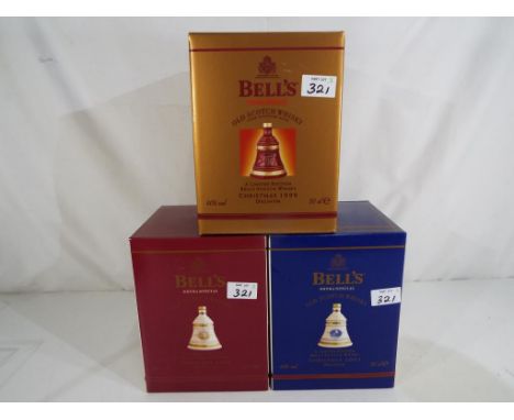 Bells Old Scotch Whisky - three Christmas decanters containing 8 year old extra special Old Scotch Whisky, 1999, 2000 and 200