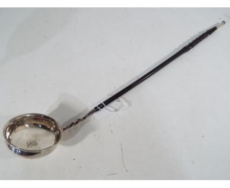 A silver punch ladle with inscribed lion emblem to the base with whale bone handle and silver mount (unmarked). Estimate £30 