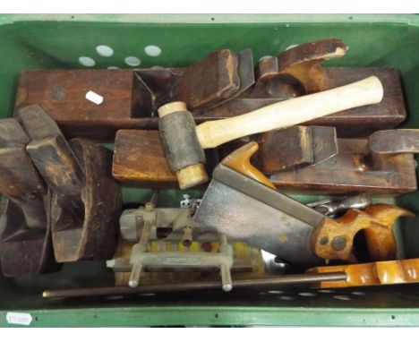 A box containing a quantity of vintage hand tools.