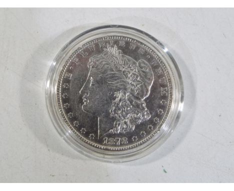 An American Morgan silver dollar 1878,  obv. Liberty head above date, rev. spreadeagle with arrows within wreath and legend, 