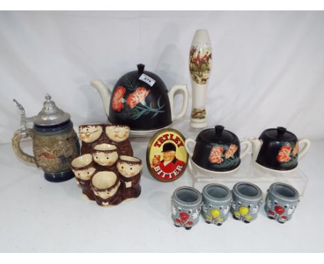 A good mixed lot of ceramics to include an unusual egg holder in the form of monks, novelty egg cup holders by Dusty Bin, a t