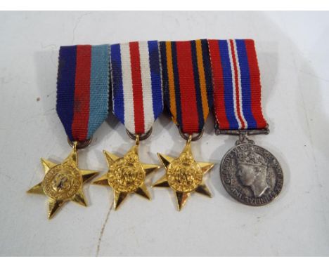 Four World War Two (WW2) miniature medals. Estimate £40 - £50  This lot MUST be paid for and collected, or delivery arranged,