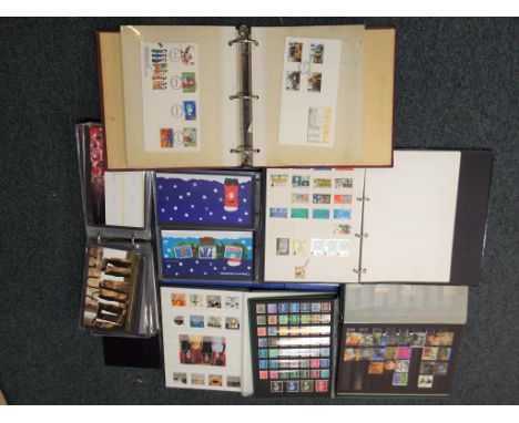 Philately - Two albums containing a quantity of UK stamps, an album containing first day covers, two albums containing a quan
