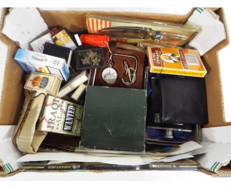 A good mixed lot to include hip flasks, cigars, vintage match books, a set of Iraqi Most Wanted playing cards, wallet, watche