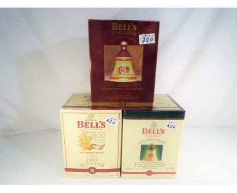 Bells Old Scotch Whisky - three Christmas decanters containing 8 year old extra special Old Scotch Whisky, 1996, 1997 and 199