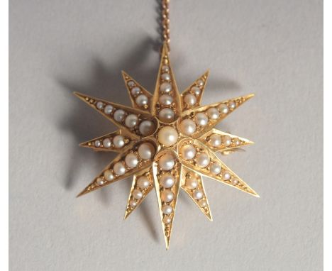 A 15CT GOLD SEED PEARL STAR BROOCH.