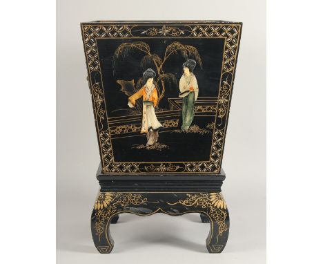 A BLACK LACQUERED PLANTER on a stand. 18ins high.