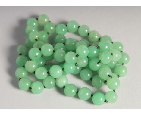 A STRING OF JADE BEADS.
