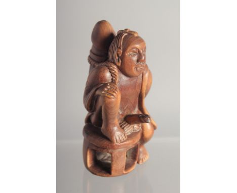 AN EROTIC CARVED WOOD NETSUKE. 2.25ins