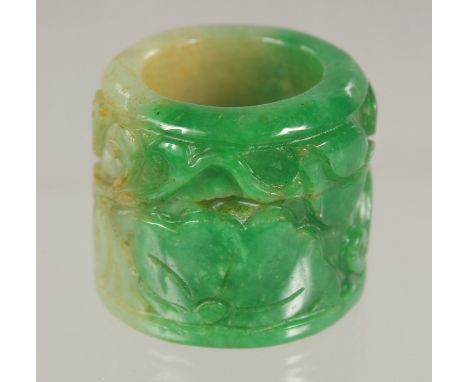 A CARVED JADE ARCHERS RING.