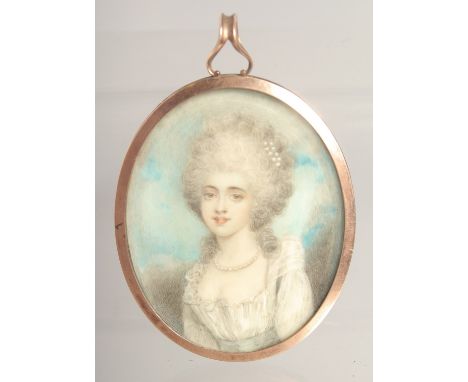 AN 18TH CENTURY OVAL PORTRAIT MINIATURE OF A LADY with blue enamel back. 2.25ins x 2.25ins.