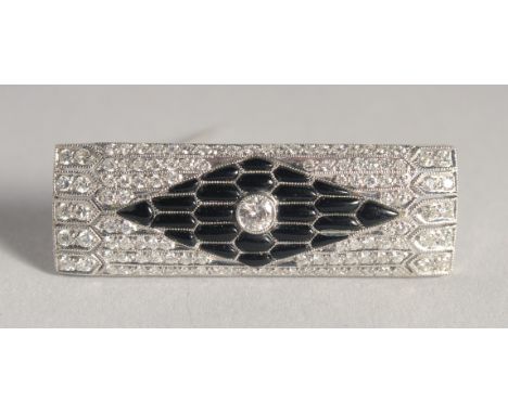 A GOOD ART DECO PLATINUM DIAMOND AND BLACK ENAMEL BROOCH. 1.5ins long.