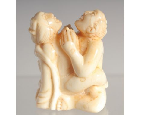 A CARVED BONE EROTIC NETSUKE. 1.5ins long.