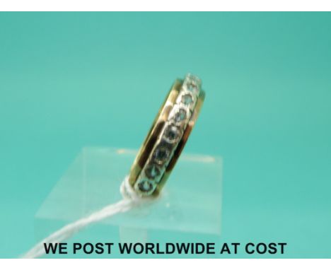 A 9ct gold eternity ring set with clear stones (size M)