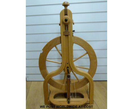 A Schacht spinning wheel with carry handle, spare band and a bobbin stand