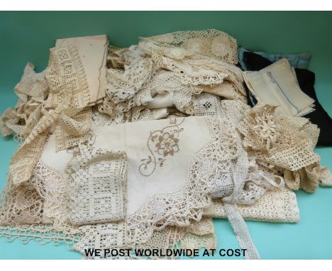 A quantity of textiles to include runners, table coverings and a fine lace table cloth together with a similar lace and embro