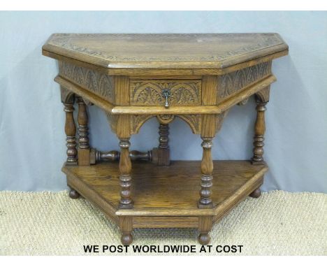 A carved oak fold over octagonal hall table with shelf below (W99 x H79cm)