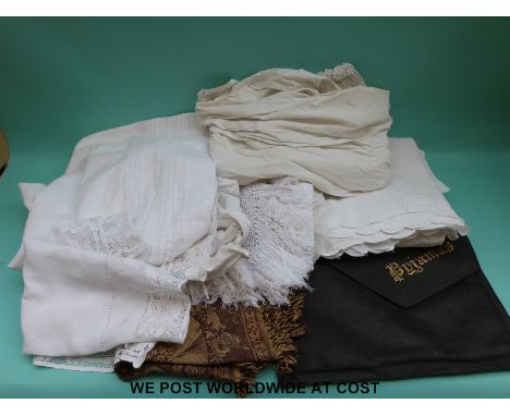 A quantity of table linen to include table cloths, runners etc, together with a girl's nightdress and undergarment with lace 