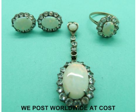 A suite of bespoke 1950's jewellery comprising pendant, ring and earrings set with oval opal cabochons and round cut paste st