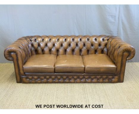 A brown leather Chesterfield button back three seater sofa (L212 x D90 x H63cm)