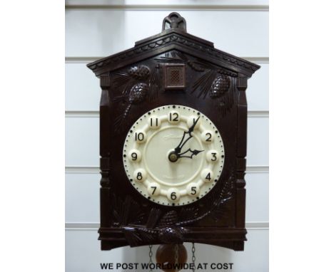 A Russian made bakelite cuckoo clock, with Arabic numerals on a contrasting ivory coloured dial 