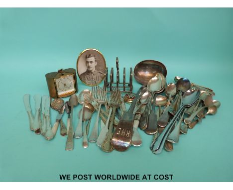 A quantity of silver plate cutlery, toast rack and a Europa travelling clock
