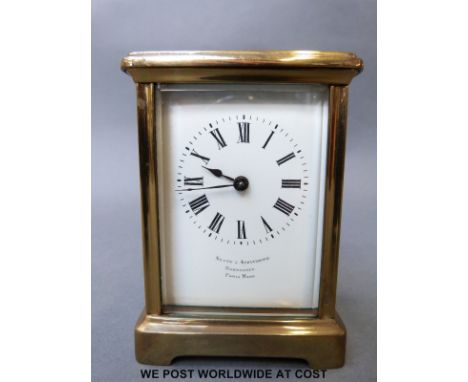 A late 19th early 20th century brass carriage clock by Paris maker, the white enamelled dial with Roman numerals inscribed by
