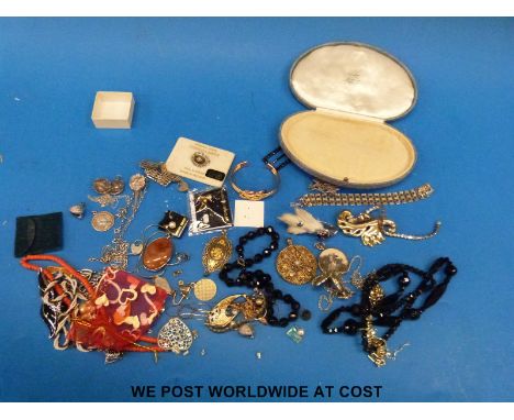 A collection of silver jewellery to include necklace, gate bracelet and pendants, costume jewellery, brooches, buckles etc 