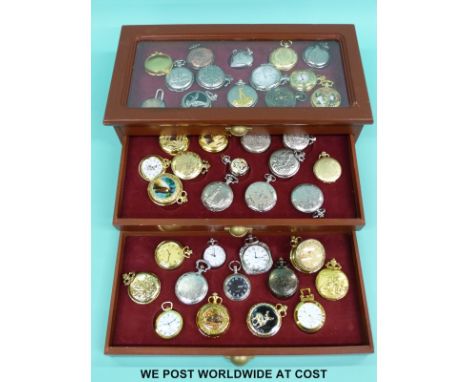 Forty highly decorated pocket watches in a fitted three drawer pocket watch collectors' cabinet. 