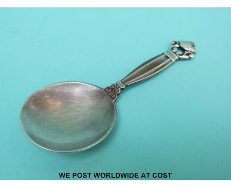 A Georg Jensen hallmarked silver caddy spoon stamped sterling Denmark and Georg Jensen Silversmiths Ltd. and with silver impo