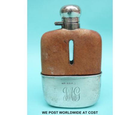 A hallmarked silver mounted hip flask with leather upper cover, bayonet cap and pull off cup, Birmingham 1953, height 15.5cm