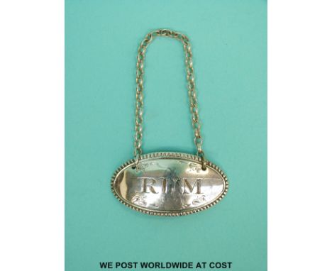 A Georgian hallmarked silver Rum bottle ticket with Georgian duty mark, no assay office or date letter, makers mark J.H possi