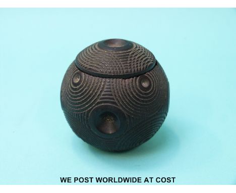 A carved spherical lignum vitae snuff box with push out container with threaded lid 