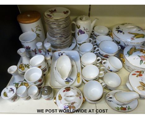 A large collection of Royal Worcester Evesham ware including tureens, casserole dishes, tea cups, salt and pepper, candle sti