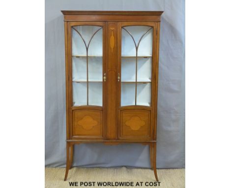 An Edwardian inlaid mahogany glazed cabinet raised on slender tapering legs (W97 x D33 x H172cm)