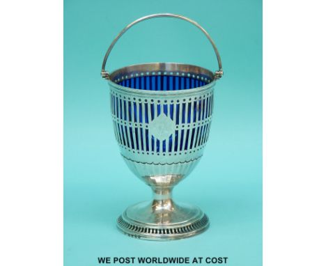 A Georgian hallmarked silver pedestal sucrier with swing handle, pierced decoration and blue glass liner, London 1812 maker S